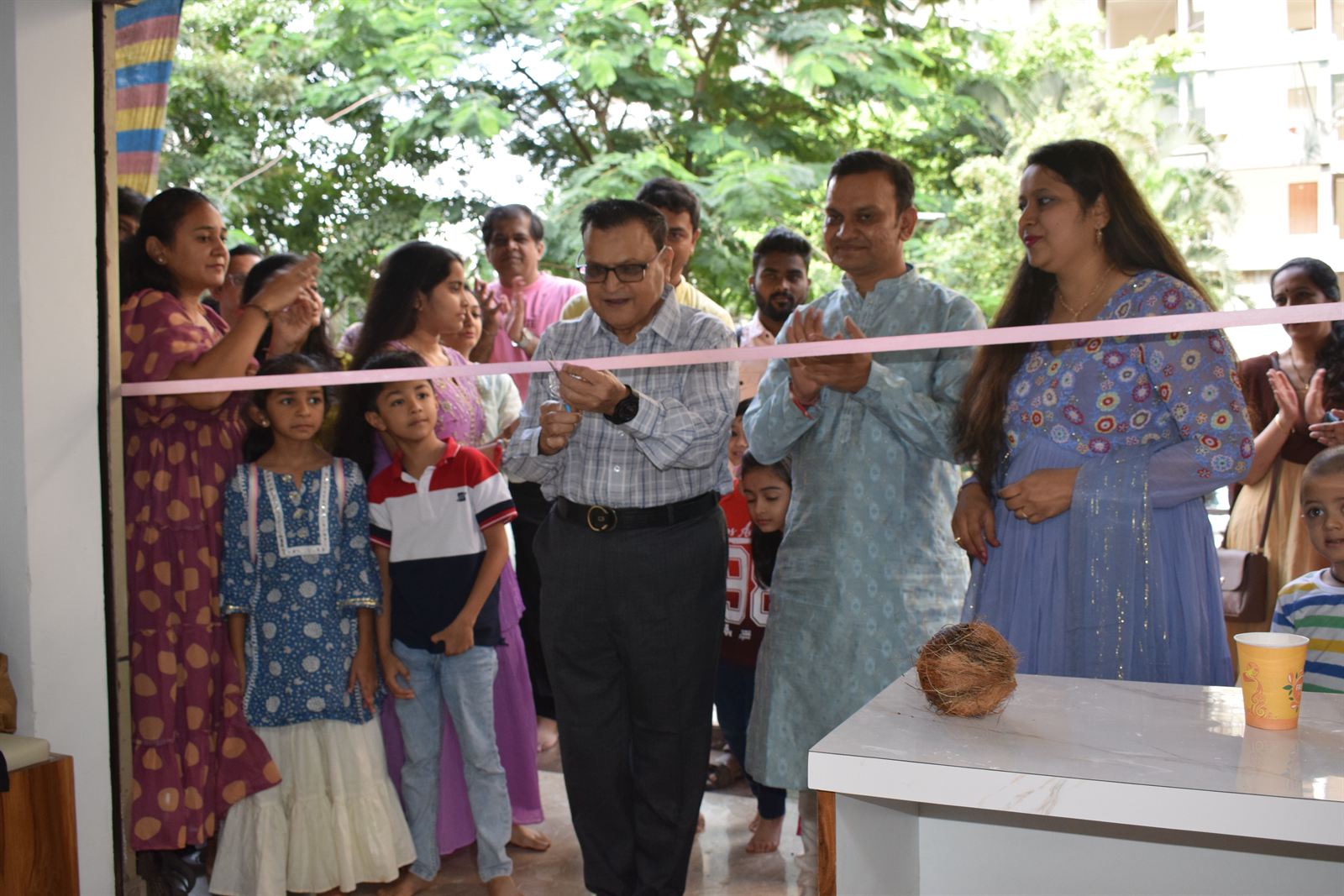 Dr. Khanna cutting the ribbon at the opening of Rupal's Diet Clinic, with Dietitian Rupal Jasani and guests